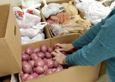
Barb Bennett, director of the Spokane Valley Partners food bank, looks over a donation of bananas and romaine lettuce delivered from Second Harvest Food Bank. The next two months are the peak season for the Valley food bank.
 (Photo by J. BART RAYNIAK / The Spokesman-Review)