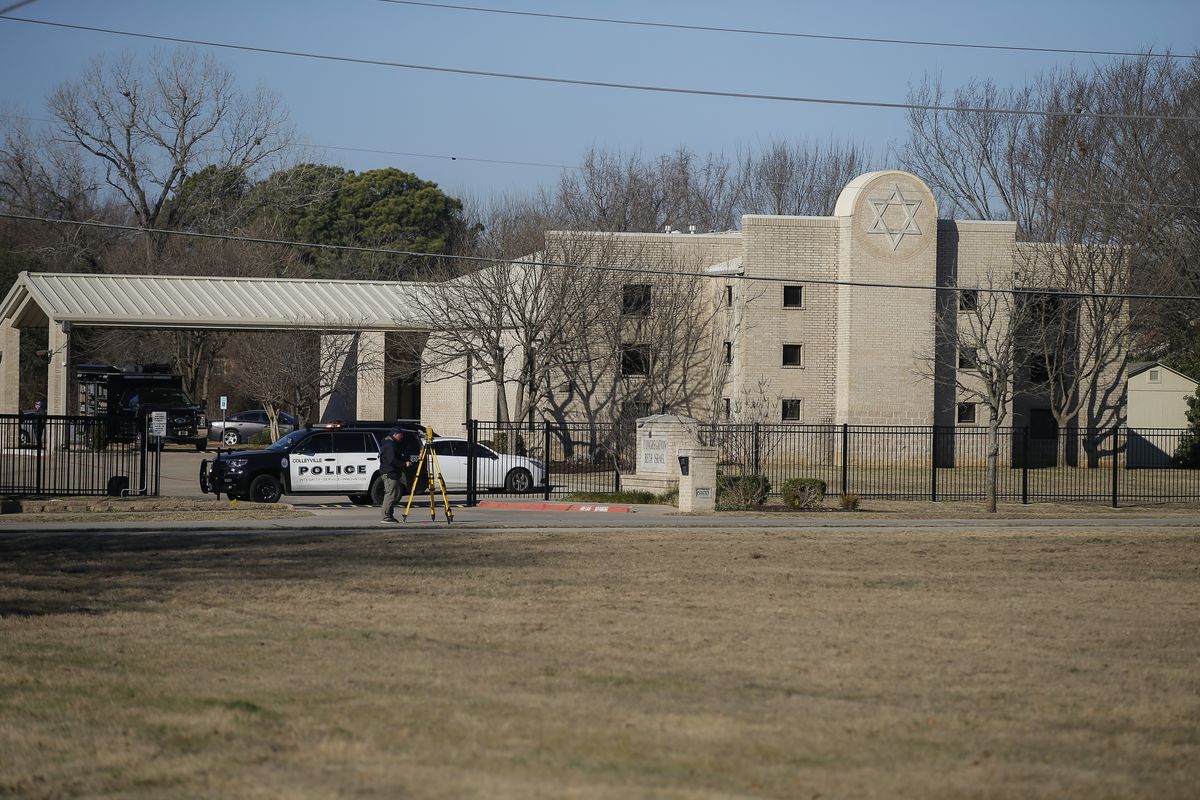 Law enforcement process the scene in front of the Congregation Beth Israel synagogue, Sunday, Jan. 16, 2022, in Colleyville, Texas. A man held hostages for more than 10 hours Saturday inside the temple. The hostages were able to escape and the hostage taker was killed. FBI Special Agent in Charge Matt DeSarno said a team would investigate "the shooting incident."  (Brandon Wade)