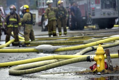 
A hose attached to a fire hydrant provides water to a pumper truck during the Blue Dolphin fire Tuesday in Spokane Valley. 
 (Holly Pickett / The Spokesman-Review)