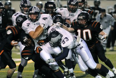 Mt. Spokane’s Colten Williams fights for yardage against a stout Lewis and Clark defense Thursday night at Albi Stadium.  (Dan Pelle / The Spokesman-Review)