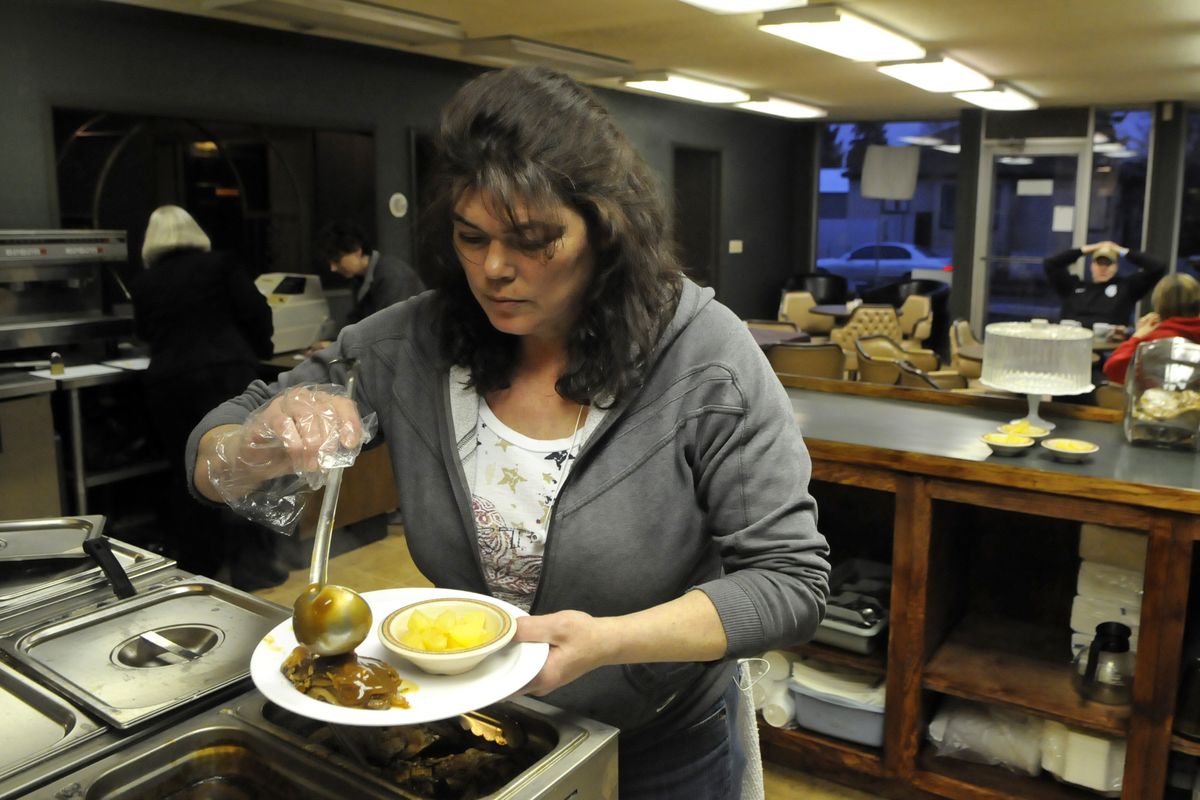 Yvonne Millspaugh, manager of the Meals on Wheels Silver Café, dishes up a dinner roast pork and gravy at the new eatery. (Dan Pelle)