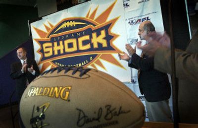 
Spokane Shock owner and CEO Brady Nelson, left, and Arena Football League president Jerry Kurz applaud Tuesday's announcement. 
 (Brian Plonka / The Spokesman-Review)