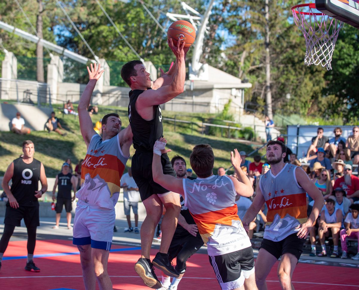 Parker Kelly, playing for Hub Northwest, puts up a shot in the paint while defended by, from left, Levi Timmermans, Trent Monkman (back turned) and Dominick Oliveri of Big and Juicy in the men’s 6-foot-and-over division on Sunday in the Riverfront Park Pavilion.  (Jesse Tinsley/THE SPOKESMAN-REVI)