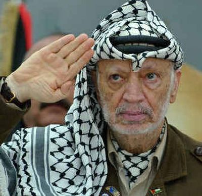 
 Palestinian leader Yasser Arafat, who died today, salutes while at his compound in the West Bank town of Ramallah in this Aug. 10 photo.
 (Associated Press / The Spokesman-Review)