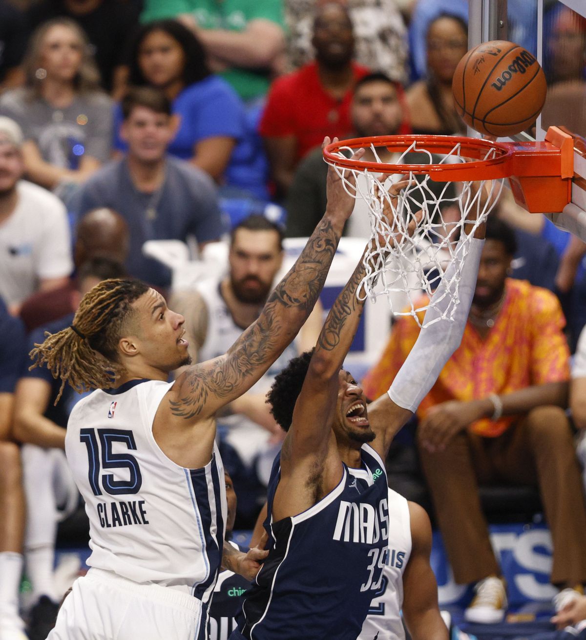 Dallas Mavericks center Christian Wood (35) attempts a layup alongside Memphis Grizzlies forward Brandon Clarke (15) during the first half of the home opener at the American Airlines Center on Saturday, Oct. 22, 2022 in Dallas.  (ElÃ­as Valverde II)
