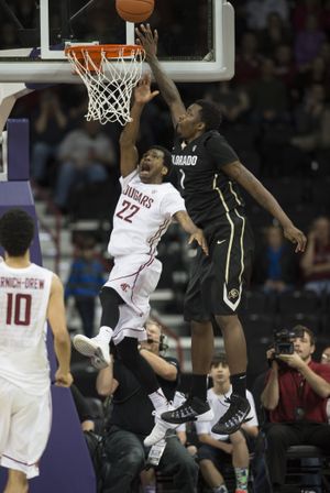 Colorado Buffaloes forward Wesley Gordon (1) taps the ball away from Washington State Cougars guard Royce Woolridge (22) during a rebound in overtime, Wed., Jan. 8, 2014, at the Spokane Arena. (Colin Mulvany / The Spokesman-Review)
