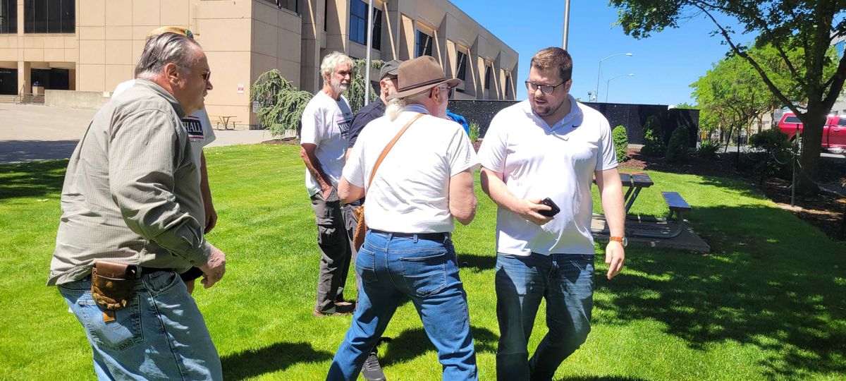 Supporters of Spokane County Commissioner candidate Molly Marshall confront John Estey, at right, at a campaign event Wednesday, June 12, 2024.  (Nick Gibson/THE SPOKESMAN-REVIEW)