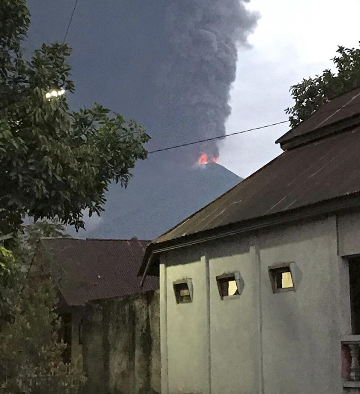 Plumes of volcanic ash rise out of Mount Soputan, on Wednesday, Oct. 3, 2018, from the village of Tombatu, North Sulawesi, Indonesia. No evacuations were immediately ordered, though people were advised to avoid the area nearest the mountain and to beware of falling ash. (Yehezkiel Dondokambey / AP)