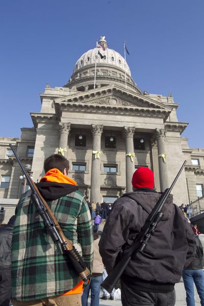 An estimated 800 pro-gun activists turned out for a rally inside the Idaho Statehouse in Boise, Idaho, Saturday, January 19, 2013. Chance Novak, 18, left, and his father, Chet Novak, both of Boise, stand outside the Idaho Statehouse after the rally. Exactly one year after it went into effect in 2016, an Idaho gun law that allows people to carry concealed firearms without a permit has had little effect on crime rates, state law enforcement officials said. (Chris Butler / Chris Butler/Idaho Statesman)