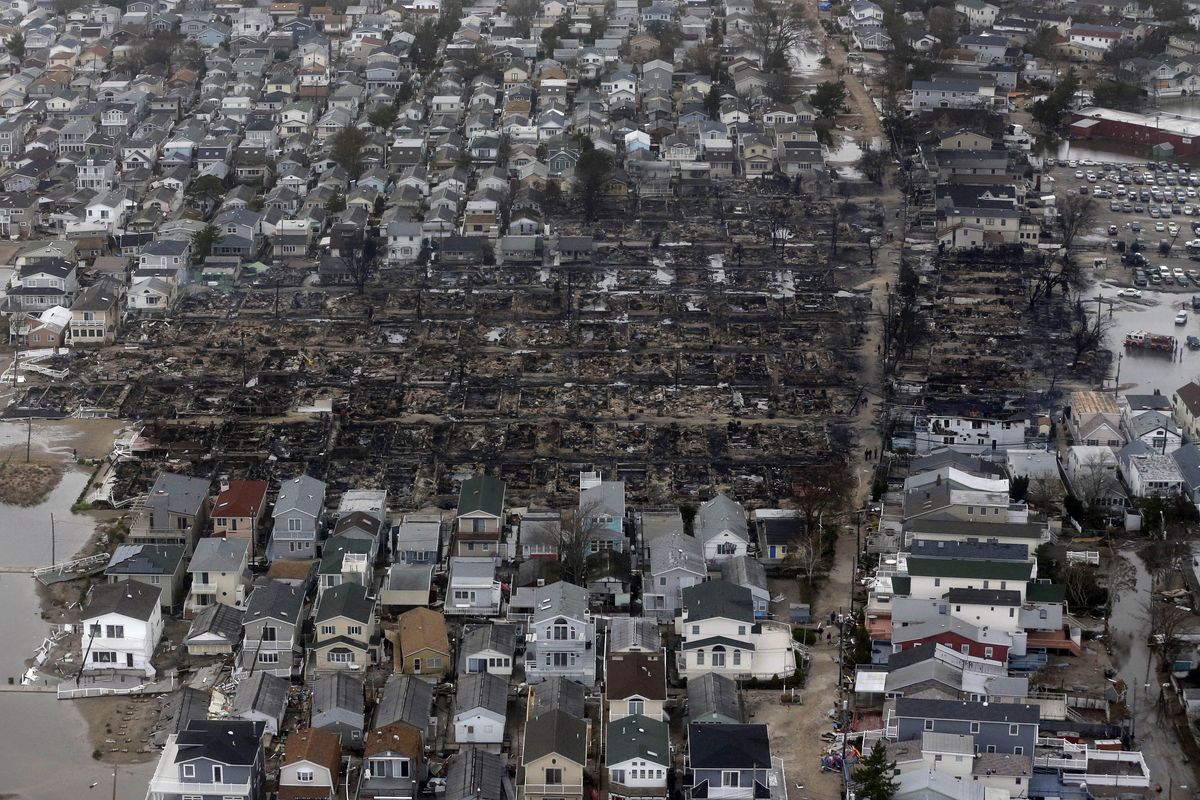 This aerial photo shows burned-out homes in the Breezy Point section of the Queens borough New York after a fire on Tuesday, Oct. 30, 2012. The tiny beachfront neighborhood told to evacuate before Sandy hit New York burned down as it was inundated by floodwaters, transforming a quaint corner of the Rockaways into a smoke-filled debris field. (Mike Groll / Associated Press)