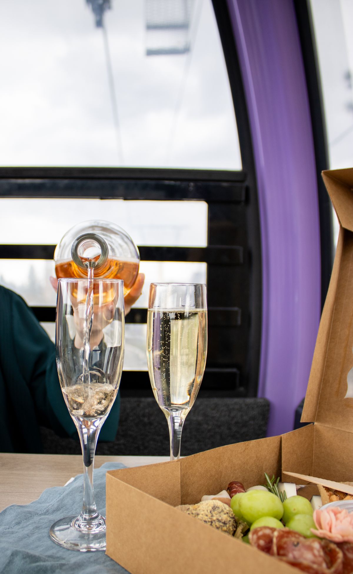 Bubbly wine and a charcuterie box is served on the Numerica SkyRide as it rides over the Spokane Falls.  (Courtesy of Riverfront Spokane)