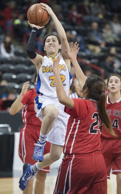Colfax guard Scout Cai shoots over White Swan’s Tionna Tillequots, right, in the 2B girls state tournament quarterfinal game on Thursday at the Spokane Arena. Cai scored 12 points for the Bulldogs in the 39-37 loss. (Jesse Tinsley)