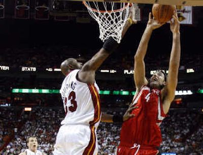 
Houston Rockets' Luis Scola, right, shoots over Miami Heat's Alonzo Mourning. Scola scored 20 points in the loss. Associated Press
 (Associated Press / The Spokesman-Review)