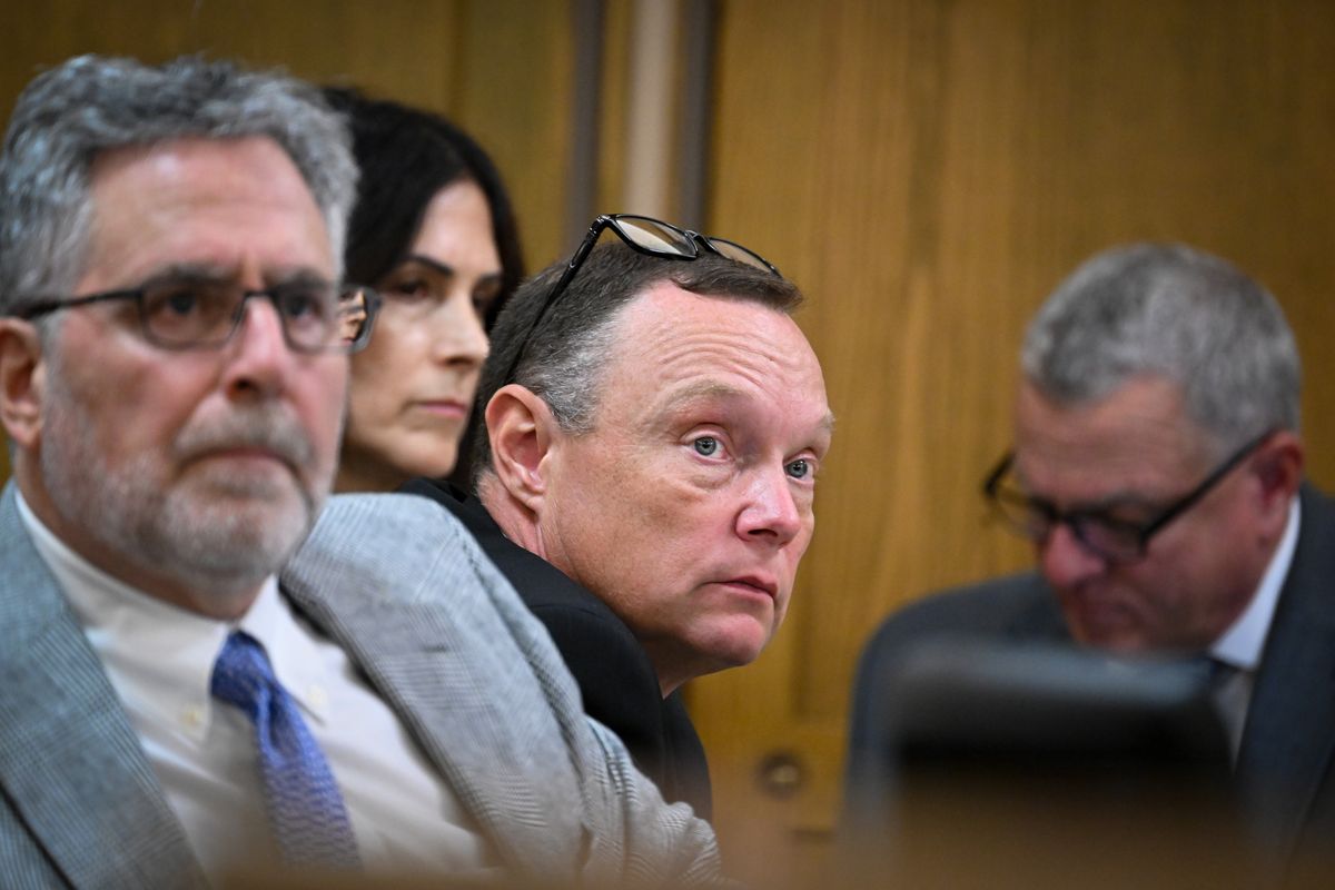 Former Spokane County Sheriff Sgt. Clay Hilton, center, listens to the opening statements of the prosecution against him, along with his attorney, Bryan Hershman on Monday in a Spokane County Superior Courtroom in Spokane. (Jesse Tinsley/THE SPOKESMAN-REVIEW)
