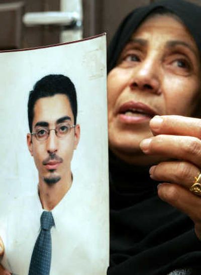 
Mohammed Asha's mother holds his picture Monday in Amman, Jordan. Asha's parents denied he was linked to any terror attacks.Associated Press
 (Associated Press / The Spokesman-Review)