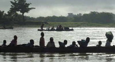 
Residents of Mirebalais are transported by canoe in June. Ex-soldiers are collaborating with the police in patrolling and operations in the community to maintain order.
 (Associated Press / The Spokesman-Review)