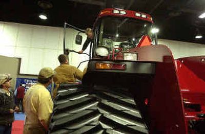 
Visitors to the Ag Expo Show check out the STX 450 Quadtrac Tuesday afternoon.
 (Brian Plonka / The Spokesman-Review)