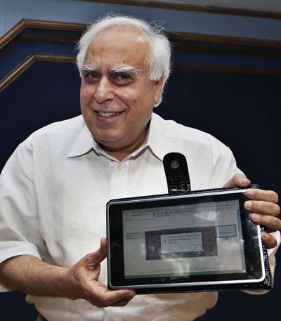  India’s Human Resource Development Minister Kapil Sibal displays the low-cost tablet at its launch in  India.  (Associated Press)