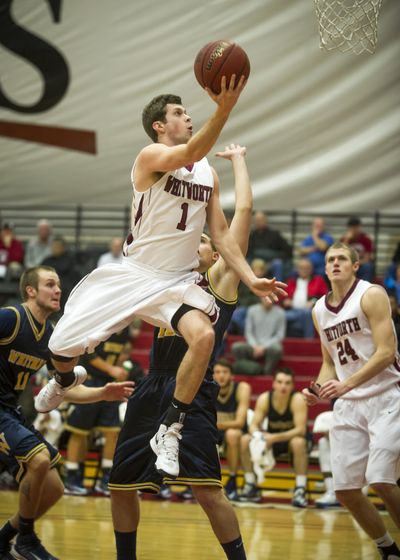 Whitworth’s Robby Douglas soars toward a layup during Tuesday’s double-OT home win over Whitman. (Colin Mulvany)