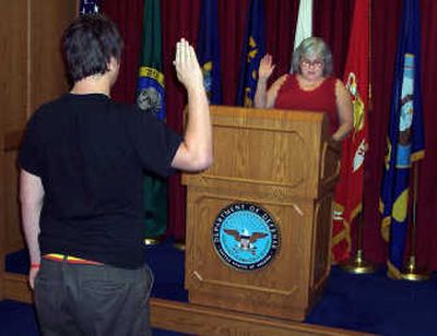 
Jake Hausmann is administered the Oath of Enlistment by his mother, retired Air Force Maj. Louanne Hausmann. Photo courtesy of Hausmann family
 (Photo courtesy of Hausmann family / The Spokesman-Review)