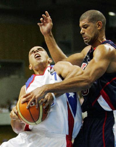 
USA's Shane Battier, right, gets a hand on the ball as Puerto Rico's Carlos Arroyo tries to shoot.
 (Associated Press / The Spokesman-Review)
