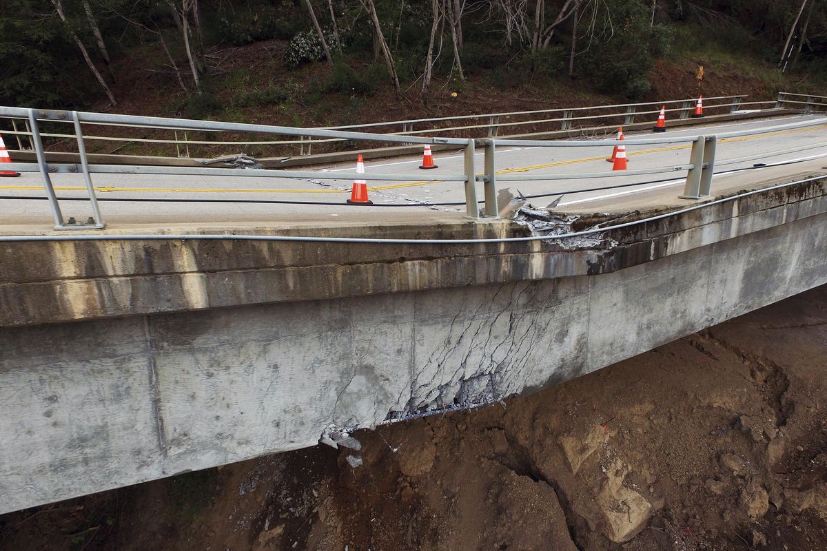 In this March 8, 2017, photo, Pfeiffer Canyon Bridge on Highway 1 is closed due to damage from storms in Big Sur, Calif. A downed bridge along the California coast has split the Big Sur area in two, stranding residents without access to grocery stores and public services and closing part of scenic Highway 1 for as long as a year. (LiPo Ching / Associated Press)