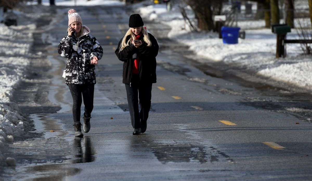 Josie Paulson, left and Emily Keenen enjoy the morning sun while walking through their Spokane Valley neighborhood on Friday, Jan. 7, 2022.  (Kathy Plonka/The Spokesman-Review)