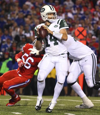 New York Jets quarterback Ryan Fitzpatrick passes under pressure from Buffalo Bills linebacker Lerentee McCray during the second half on Thursday. (Bill Wippert / Associated Press)