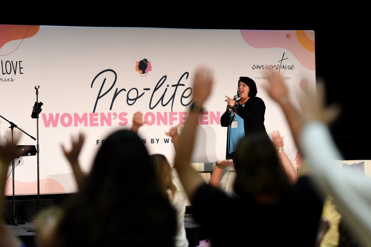Bethany Bomberger leads attendees in the wave before the start of the annual Pro-Life Women’s Conference in St. Charles, Mo., on Friday.  (MARTA PAYNE/New York Times)