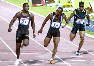 
American Justin Gatlin, left, tied the men's 100-meter world record last month in Qatar. 
 (Associated Press / The Spokesman-Review)