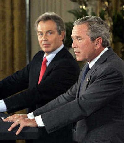 
President Bush answers a reporter's question as British Prime Minister Tony Blair listens during a news conference at the White House on Tuesday. 
 (Associated Press / The Spokesman-Review)