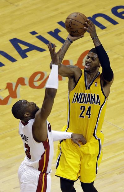 Pacers’ Paul George shoots over Heat’s Dwyane Wade. George finished with 22 points. (Associated Press)