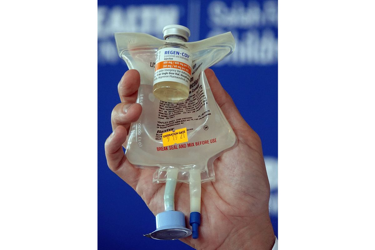 Dr. Aldo Calvo, medical director of family medicine at Broward Health, shows a Regeneron monoclonal antibody infusion bag during a news conference Aug. 19 at the hospital in Fort Lauderdale, Fla.  (Joe Cavaretta)