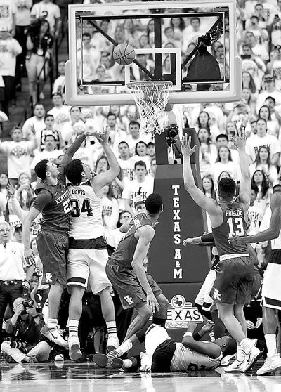 Texas A&M's Tyler Davis (34) makes a shot at the buzzer in OT. (Sam Craft / Associated Press)