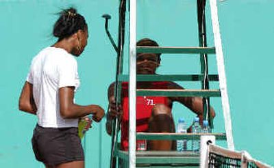Venus, left, and Serena Williams take a break from their practice session Sunday.Venus, left, and Serena Williams take a break from their practice session Sunday.
(Associated PressAssociated Press / The Spokesman-Review)