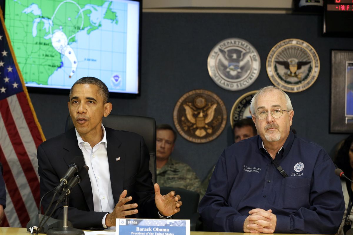 President Barack Obama speaks as he attends a briefing with Federal Emergency Management Agency administrator Craig Fugate, right, at the National Response Coordination Center at FEMA Headquarters in Washington, Sunday, Oct. 28, 2012. (Jacquelyn Martin / Associated Press)