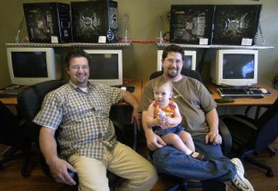 
Brothers Ted, left, and  Tom Brown, holding his daughter Emeliya, have moved their business, Inland Northwest Gaming  and Systems, to Spokane Valley.
 (Liz Kishimoto / The Spokesman-Review)