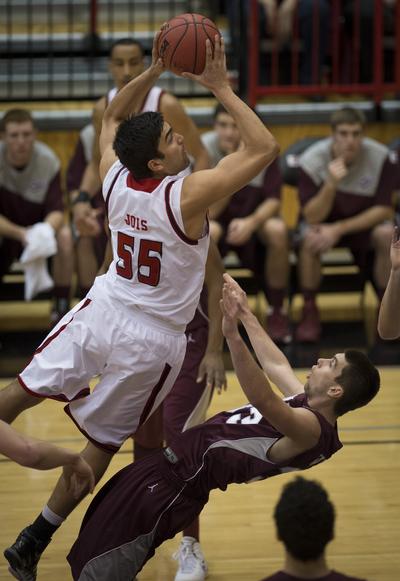 Eastern Washington forward Venky Jois (55) drives to the basket as Montana forward Michael Weisner (33) falls during the first half of a men's college basketball game, Wed., Jan. 9, 2014, on Reese Court in Cheney, Wash. (Colin Mulvany / The Spokesman-Review)