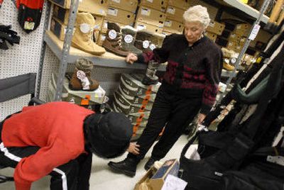 
Lois Huber, right, shows customer Barbara Baker her own Sorel hiking boots which she wears to work in Coeur d'Alene. Huber has has worked in retail for more than 50 years. But these days she's known as the 