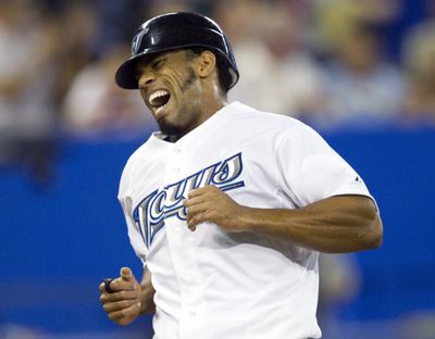 Toronto Blue Jays' Eric Thames yells as he crosses the plate to score on a double by Jose Bautista double during the sixth inning of a baseball game against the Seattle Mariners, Thursday, July 21, 2011, in Toronto.  (Associated Press)