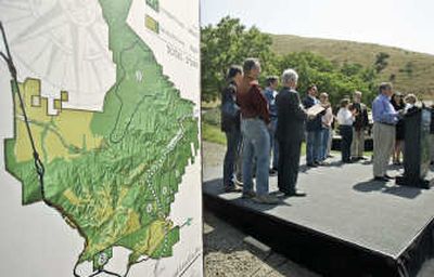 
Tejon Ranch Co. CEO Bob Stine, at podium, and a group of conservationists hold a news conference Thursday in Lebec, Calif., to announce a deal on development of the ranch. Associated Press
 (Associated Press / The Spokesman-Review)