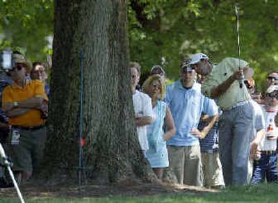 
Sergio Garcia hits from behind a tree on the fourth hole during the third round. 
 (Associated Press / The Spokesman-Review)