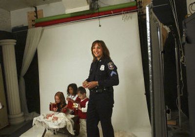 
Detective Stephanie Barkley poses for a photographer last month at Libby Studios for the cover of an upcoming Christmas CD. 
 (Brian Plonka / The Spokesman-Review)