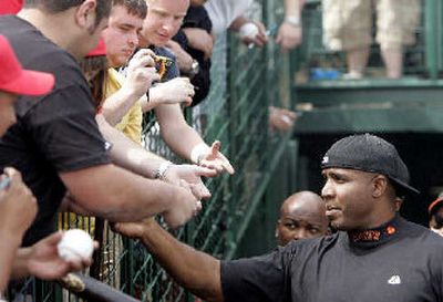 
Barry Bonds hands out baseball cards to fans  in Tempe, Ariz. 
 (Associated Press / The Spokesman-Review)