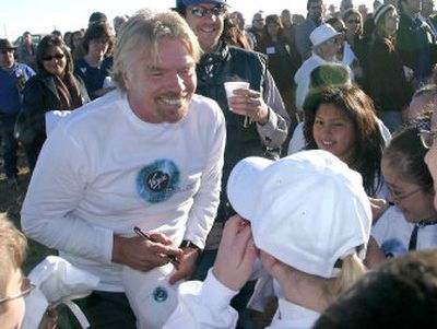 
Entrepreneur Richard Branson signs autographs Wednesday in Upham, N.M.
 (Associated Press / The Spokesman-Review)