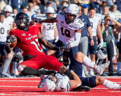 EWU running bakc Micah Smith (23) gets tripped up by Montana State defender Nolan Askelson (34) in the Big Sky Conference matchup Saturday, Sept. 24, 2022.  (Jesse Tinsley/THE SPOKESMAN-REVIEW)