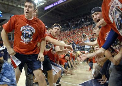 
Gonzaga University Kennel Club members anticipate the arrival of sophomore basketball player Jeremy Pargo as they form a tunnel for player introductions before the start of Gonzaga's first game against Augustana on Wednesday night in the McCarthy Athletic Center.
 (Dan Pelle / The Spokesman-Review)
