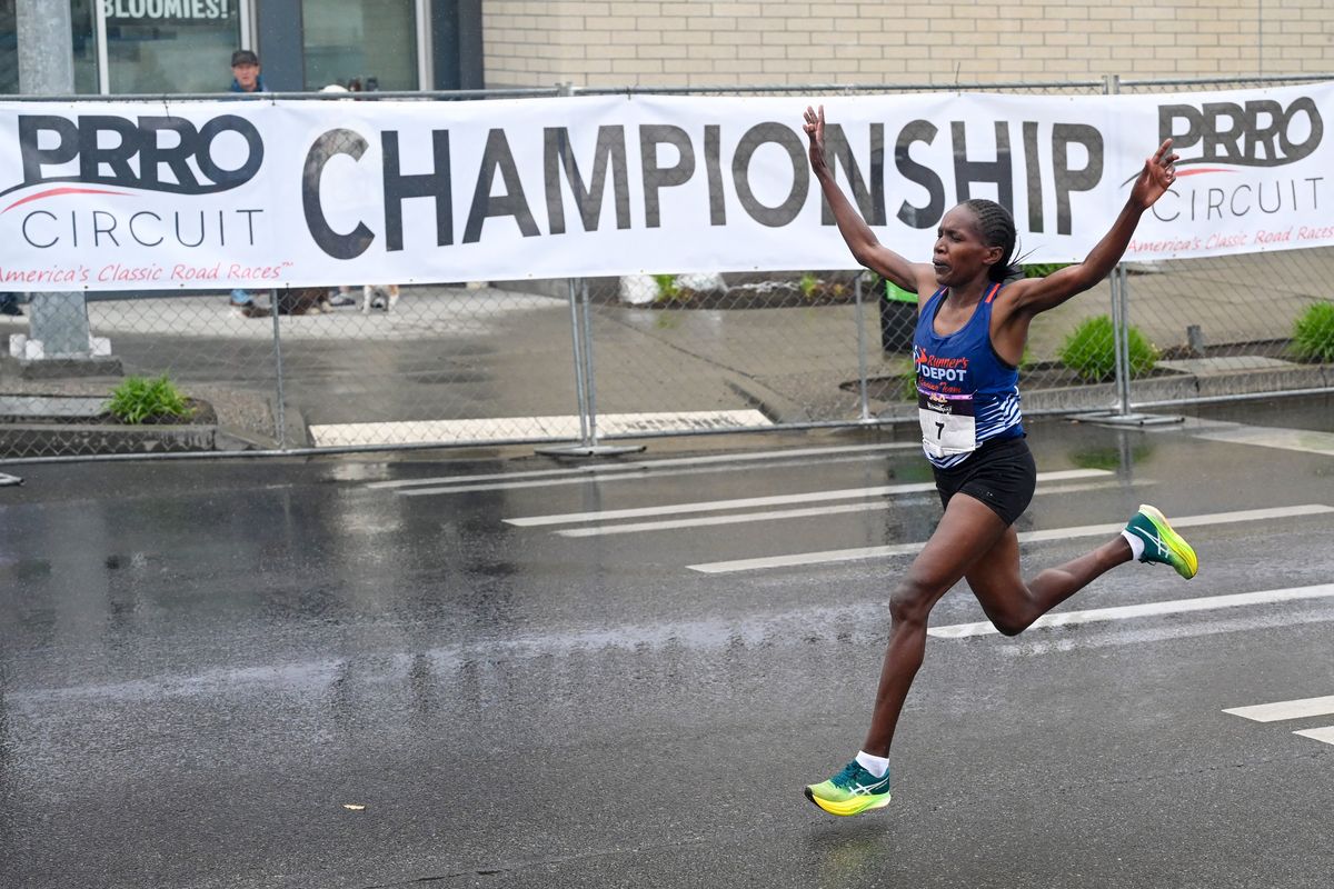 Sarah Naibei (7) of Kenya prepares to cross the finish line on Monroe Avenue to win in the women