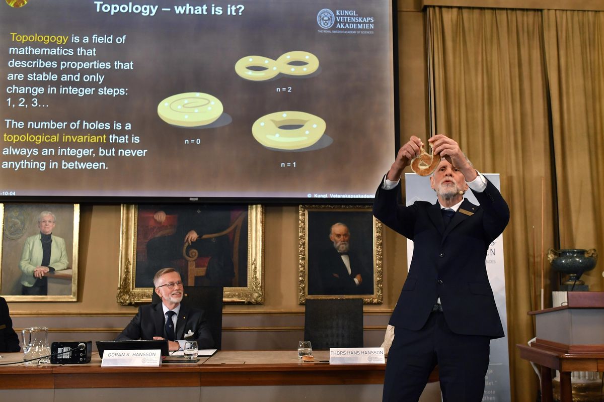 Professor Thors Hans Hansson gives a demonstration, after revealing the winners of the Nobel Prize in physics, at the Royal Swedish Academy of Sciences, in Stockholm, Sweden, Tuesday, Oct. 4, 2016. David Thouless, Duncan Haldane and Michael Kosterlitz have won the Nobel physics prize. Nobel jury praises physics winners for ‘discoveries of topological phase transitions and topological phases of matter’. (Anders Wiklund / TT via AP)