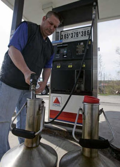 
Joe Marcello Sr., of the Schenectady County weights and measures department, tests pump efficiency at a station in Duanesburg, N.Y., on Wednesday. Associated Press
 (Associated Press / The Spokesman-Review)
